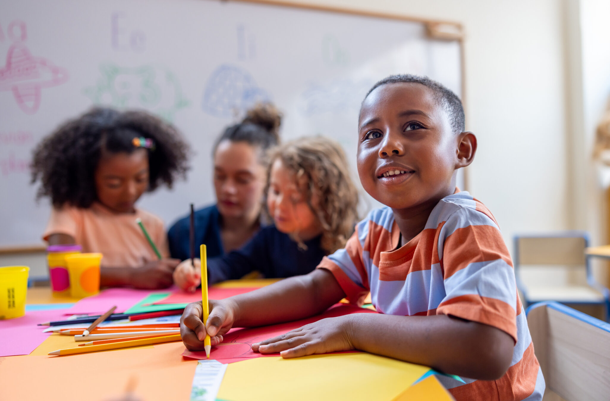 Pre-K student participating in a classroom learning activity at a Maryland State Department of Education-approved public pre-kindergarten program, building school readiness through hands-on learning and teacher-guided instruction.