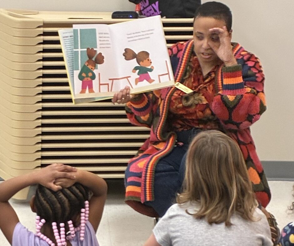 Teacher reading a storybook to preschool children during circle time, supporting early literacy, listening skills, and classroom engagement