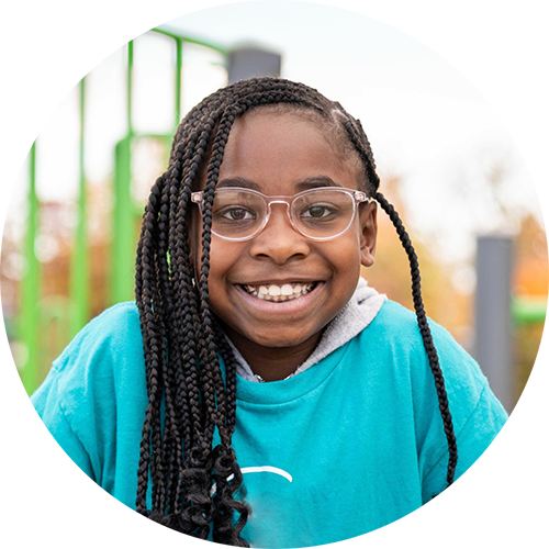 A smiling school age girl in the before and after school care program. 