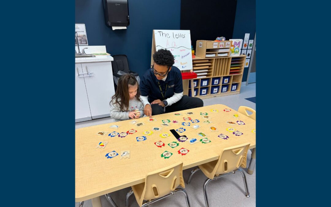 Photo of a teacher and child working on an activity
