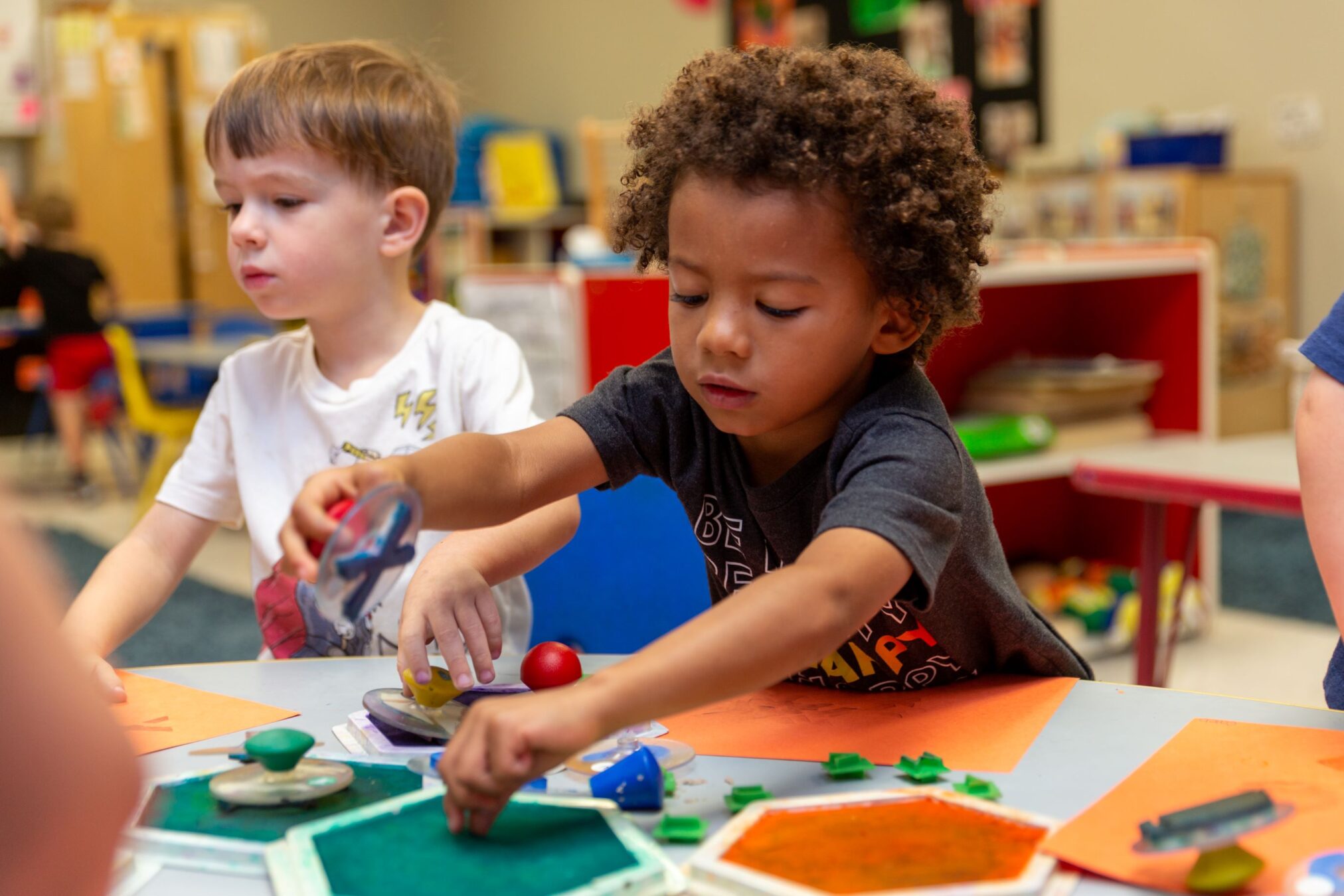 Preschool children participate in hands-on art activities, using paint and materials to build creativity, fine motor skills, and early learning in a classroom setting.