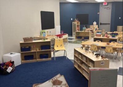 a fun and engaging preschool classroom with a blue carpet and gray and blue walls.