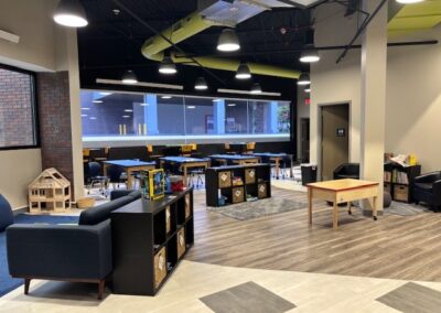 Modern and spacious learning area with tables and seating.