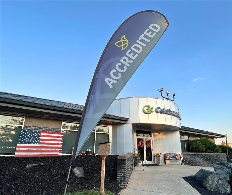 a Celebree school building with "Accredited" flag displayed