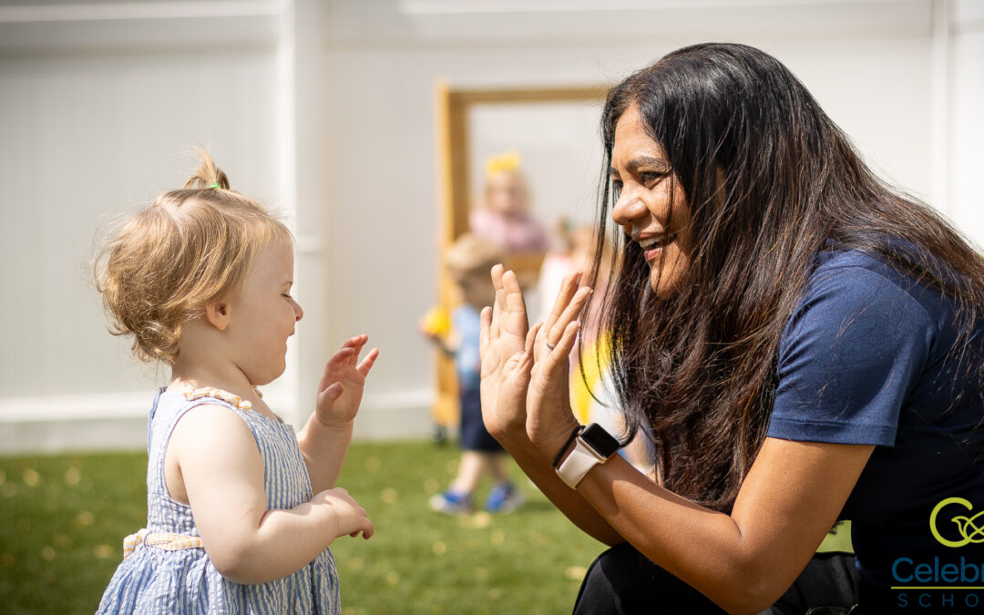 Celebree School of Warrington owner, Nita Solanki, smiling and high-fiving a young child during outdoor playtime, showing warmth, connection, and care.