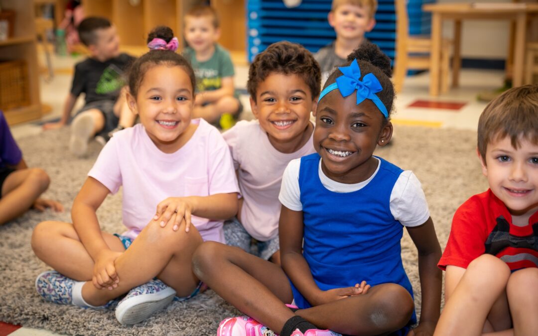 Preschool children at Celebree School of Warrington engaged in imaginative play and learning activities in a colorful classroom setting.