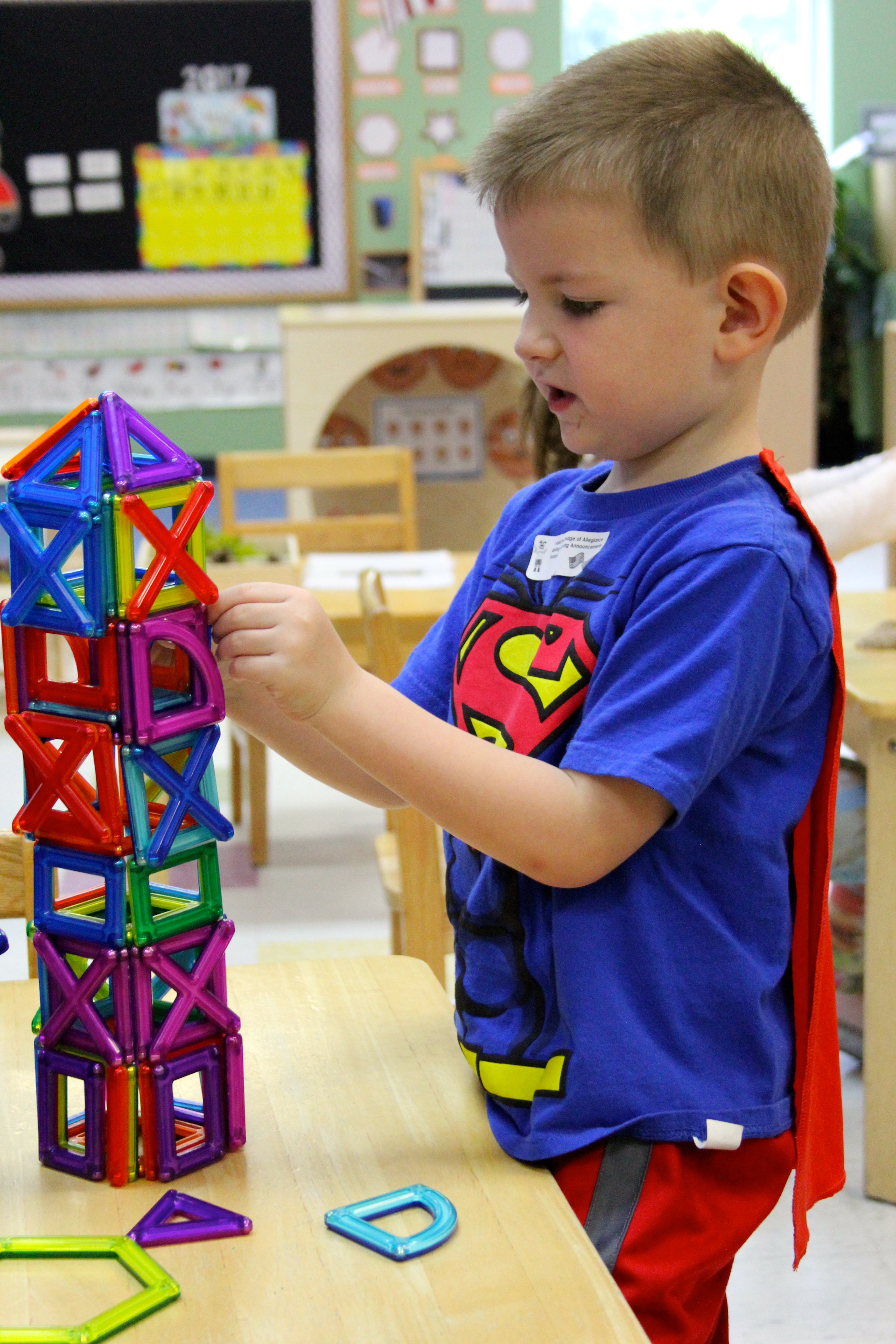 a boy building a toy tower
