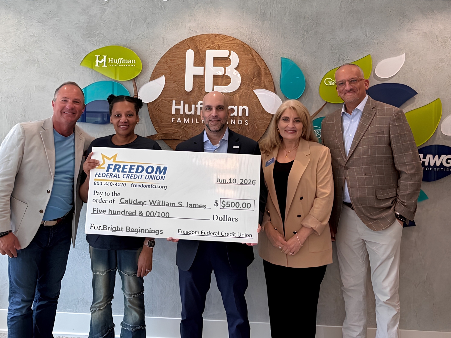 Freedom Federal Credit Union and Huffman Family Brands representatives present a Bright Beginnings Grant award to a Caliday at William S. James educator, supporting innovative early childhood education and student enrichment initiatives.