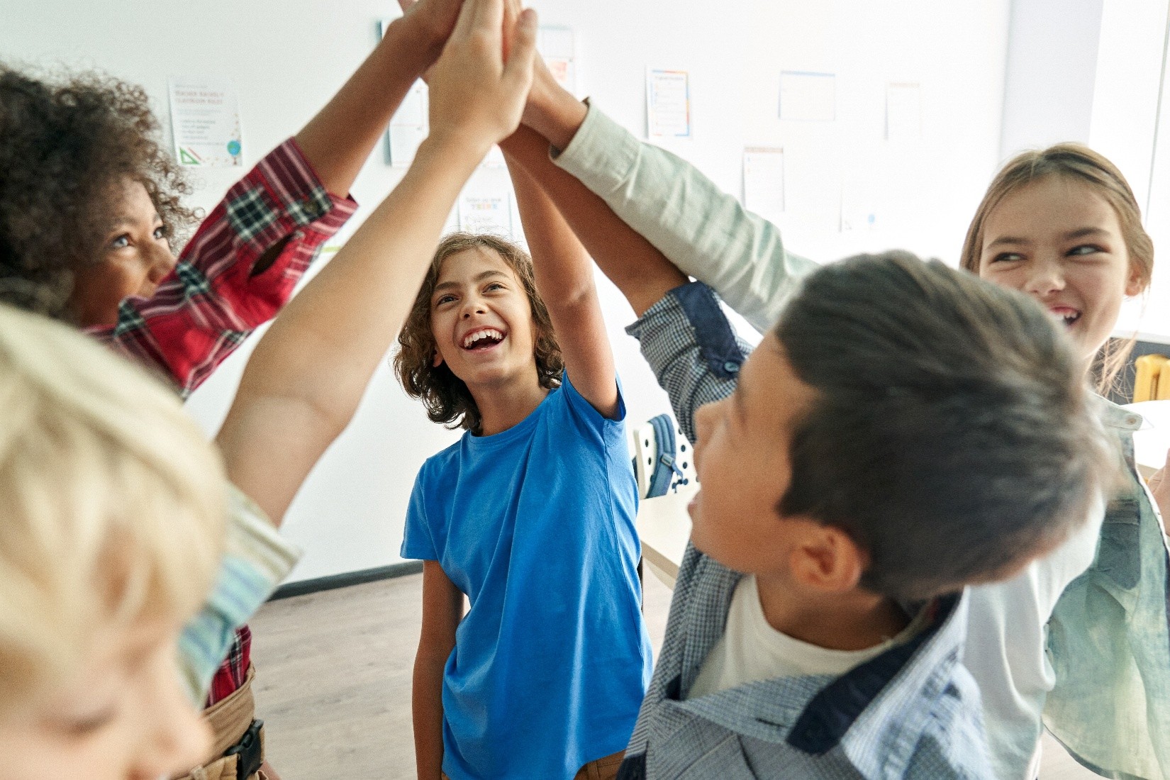 Elementary school kids during the after-school program giving each other a high-five. 